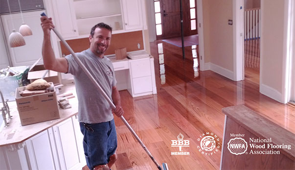Roy working on a hardwood floor